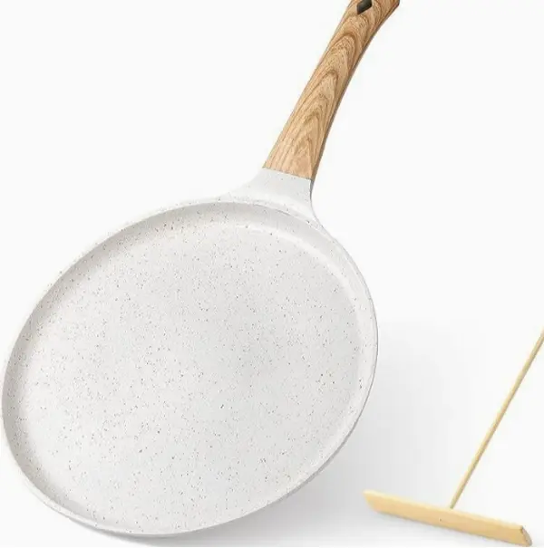 Clean white speckled crepe skillet with natural wooden handle, aesthetic cooking pan that elevates food photos and matches light-colored modern kitchen decor.