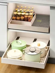 Expandable pull-out cabinet storage rack with heavy-duty sliding shelves. Easy installation without drilling, suitable for storing pots, pans, and condiments.