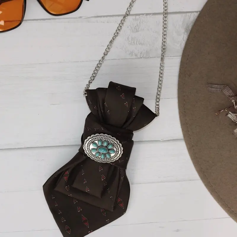 Women’s tie brown with funky turquoise brooch on a chain