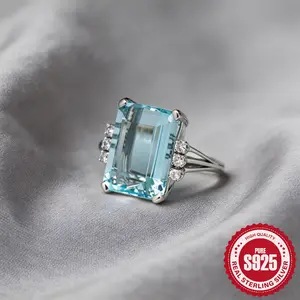 A Single Piece of S925 Sterling Silver Ring Featuring an Emerald Cut Aquamarine, Designed for Both Men And Women, with Side Step Cut Crystal Accents, Making It a Striking Statement Piece for March Birthdays, Suitable for Everyday Use