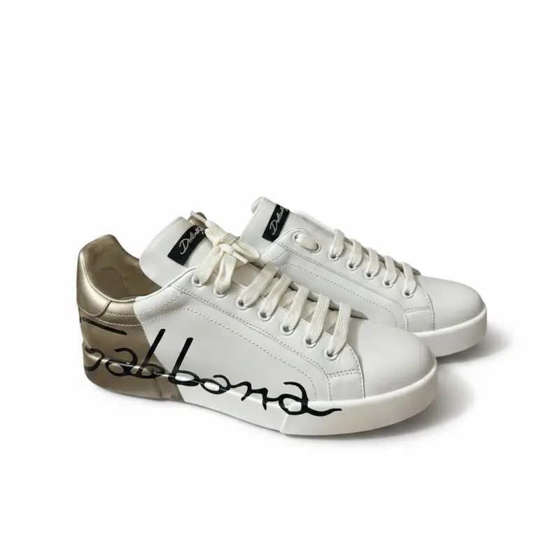 Dolce & Gabbana sneakers with a black graffiti-style logo and gold detailing Size 41