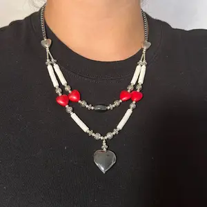 Navajo handmade double strand puff hematite heart pendant necklace adorned with grade A white clam shell heishi beads, hematite and red magnesite heart shaped beads.