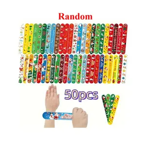 50pcs Christmas clapping hand ring party gifts with random patterns, Christmas palm bracelets for Christmas party decoration featuring festive designs in PVC, holiday-themed bag fillers with festive patterns.