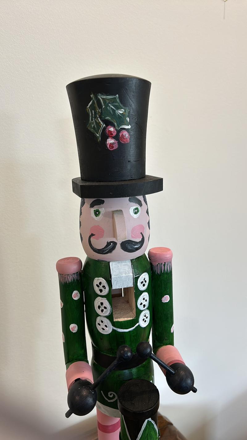 Hand-painted wooden nutcracker. He measures 24 inches tall. “Gunner” is a handsome guy that absolutely can live in your space year round.