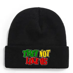 S&T They're Not Like Us Juneteenth Black History Knitted Hat - Bold Statement Winter Hat with Green, Yellow, Red, Black, and White Letters - Soft 100% Acrylic Knit with Elastic Cuff - Unisex - Juneteenth Celebration African American Pride  - Casual and Fe