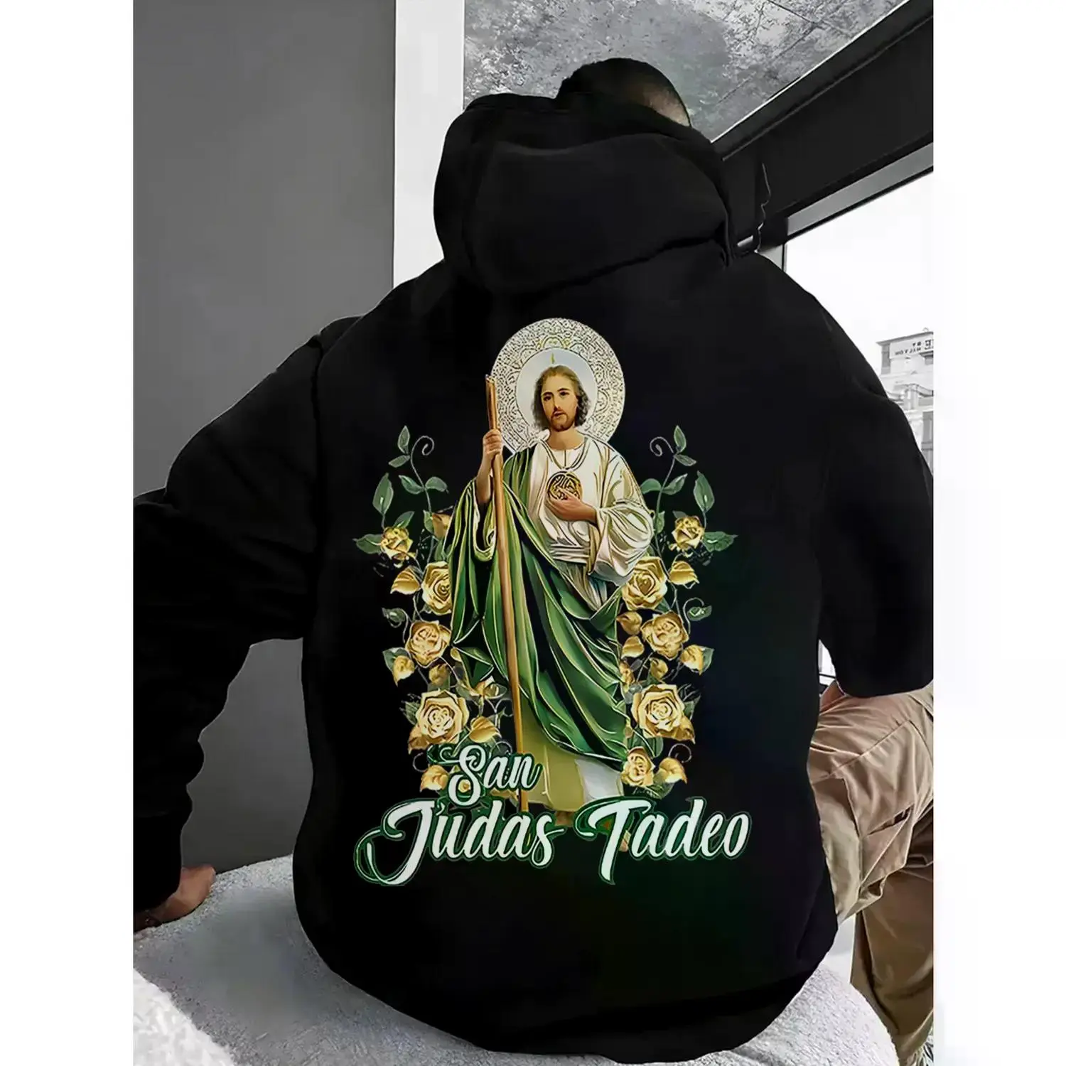 Casual Unisex Long Sleeve Graphic Hoodie Featuring Saint Judas Tadeo and Saint Jude with Artistic Green Back Print for Streetwear and Religious Style