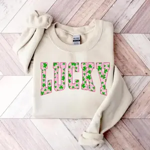 The sweatshirt features a green clover design, perfect for St. Patrick's Day. This is a cute Irish holiday sweatshirt that blends holiday style and comfortRAIMENTRY