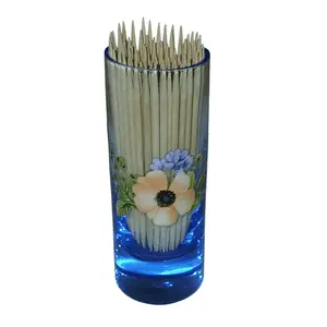 Blue glass shot glass with toothpicks