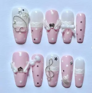 Sweet pink melody nails – soft pastel pink with white lace, pearls, and rhinestone hearts, creating a dreamy, girly design that shines with romantic and musical charm.