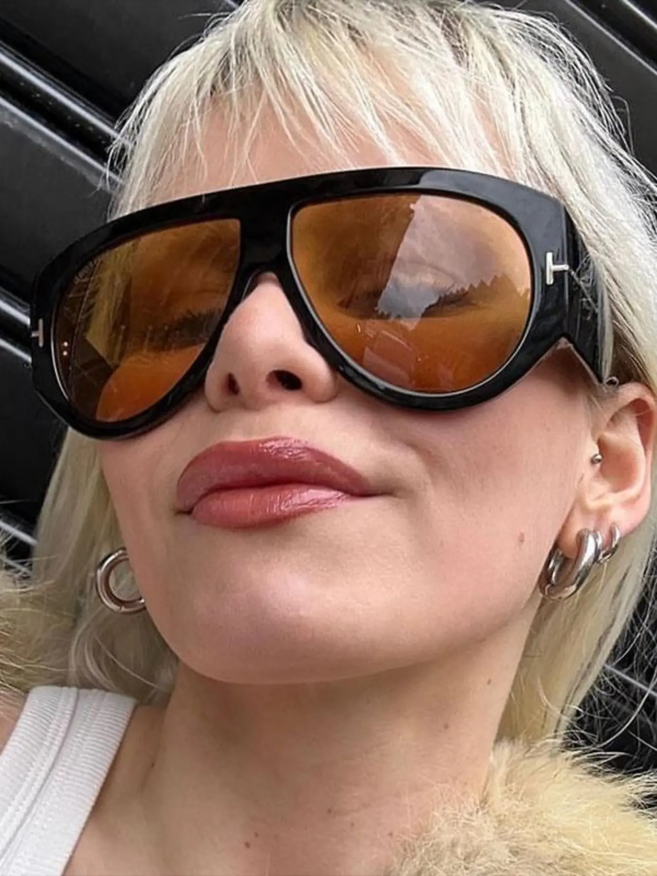 Model wearing oversized aviator sunglasses front view