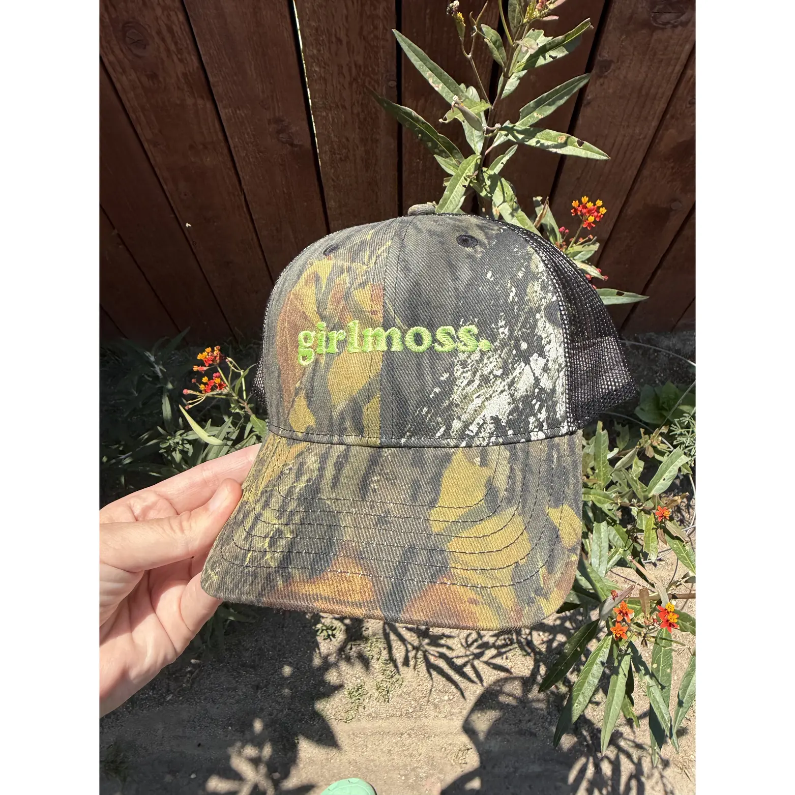 Girlmoss unstructured on camo dad hat with lime green thread.