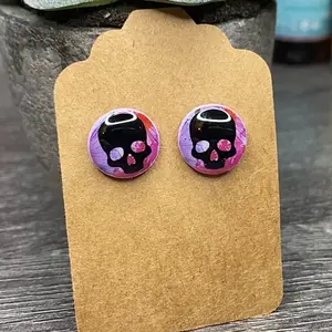 Black Skull Studs on Pretty Purple & Pink Watercolor Background.
