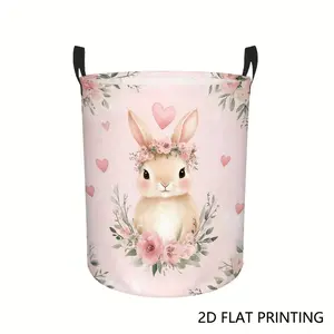 A pastel-colored small laundry basket featuring a floral rabbit design with hearts, foldable for easy storage, and equipped with durable handles, suitable for use in bedrooms and bathrooms.