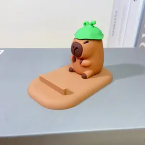 Two random new creative designs of cute capybara cartoon figurines, lazy person stand, desktop phone stand, and creative decorative gifts