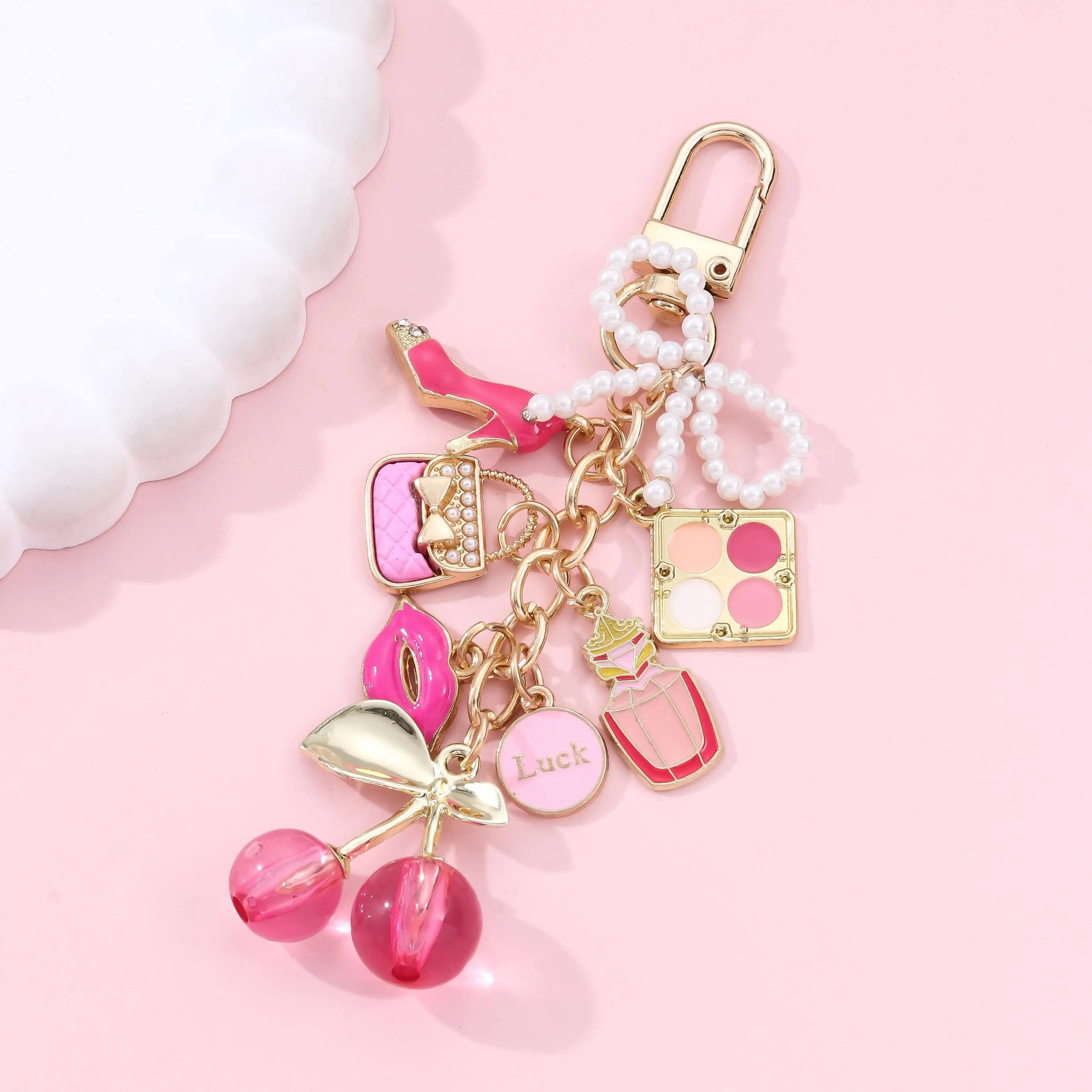 Toy pendant / Toy charm 1 Vintage-style elegant alloy keychain—featuring a blend of lipstick, pearl, bow, cherry, and perfume bottle elements crafted with an enamel finish; suitable as a bag charm.