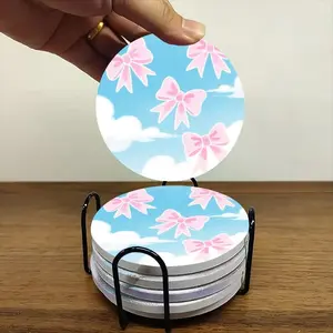 6-piece ceramic coaster set, featuring a whimsical illustration of pink bows and blue skies with white clouds. These heat-resistant, non-slip coasters come with a stand and are perfect for home, dining, or as beverage mats.