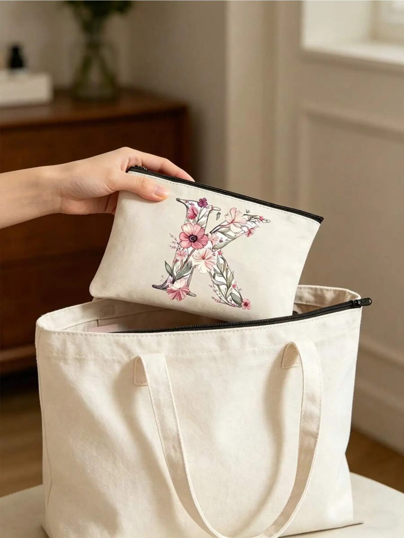 Personalized canvas makeup bag with floral A-Z letters. Zippered design stores cosmetics, skincare and small jewelry. Compact and portable for daily use, travel and school. Perfect gift for teachers, bridesmaids and special occasions.