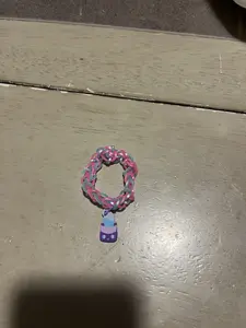 Handmade rubber band bracelet customizable with different colors, beads, and charms