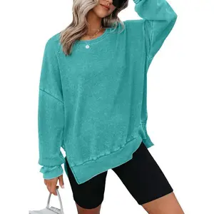 Women’s oversized waffle-knit crewneck sweatshirt with long sleeves and side slits—casual pullover knit top that can be paired with a raincoat