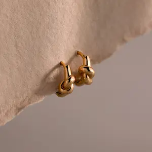 Love Knot Huggies by Caitlyn Minimalist - Dainty Twisted Knot Charm Earrings - Stackable Huggie Hoop Earrings in Gold & Silver - Minimalist Wedding Jewelry - Graduation Gift