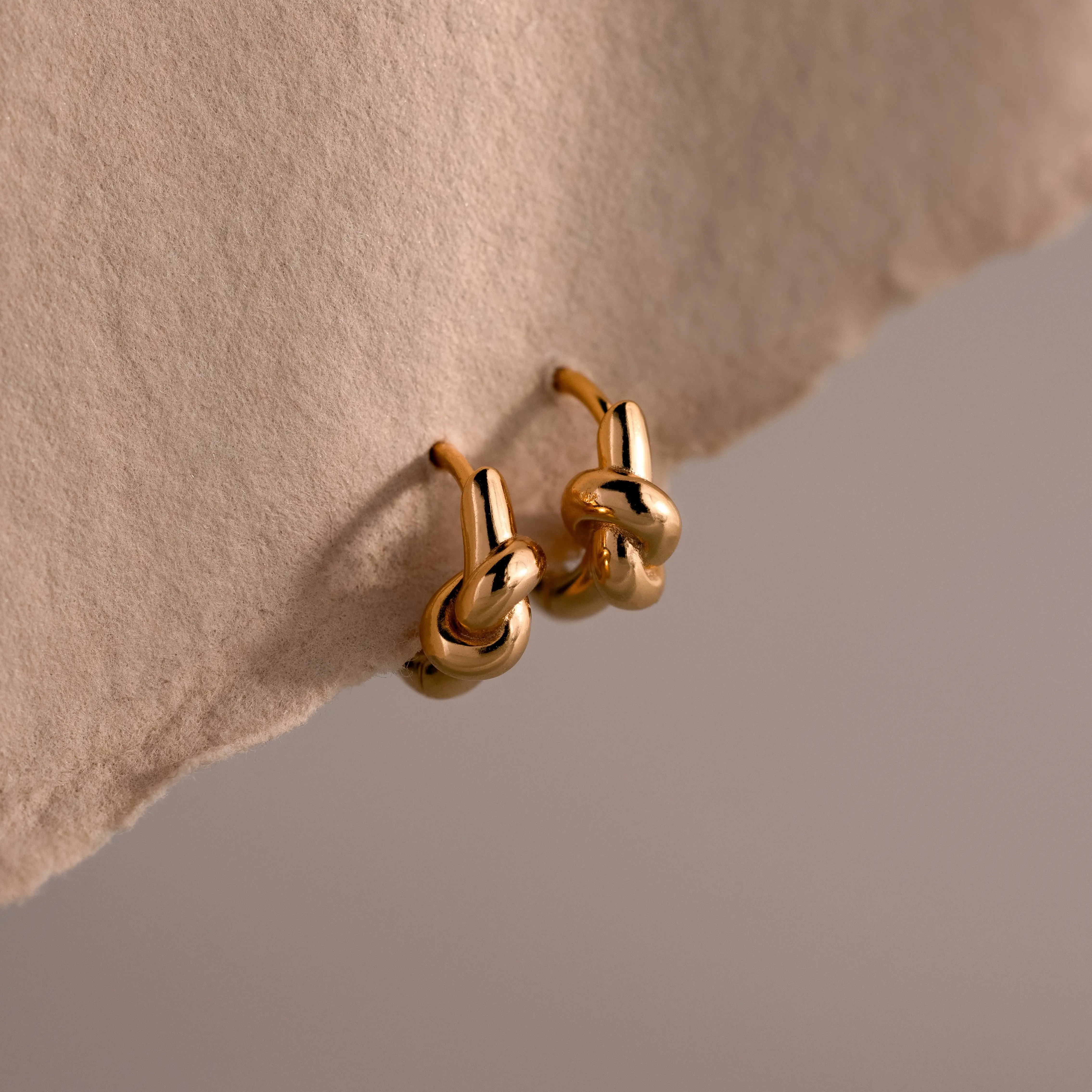 Love Knot Huggies by Caitlyn Minimalist - Dainty Twisted Knot Charm Earrings - Stackable Huggie Hoop Earrings in Gold & Silver - Minimalist Wedding Jewelry - Mom Gift