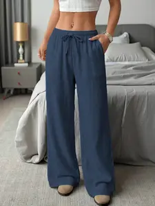Women’s long pants with a drapey feel, side pockets, and an elastic waistband with drawstring—perfect for home and casual outings; essential for summer—comfortable, cool, and super versatile.