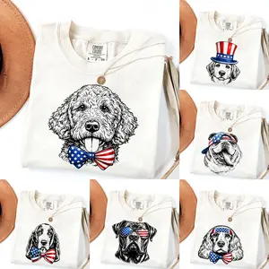 Puppy Love Dog T-shirt Showcasing 50 dog breeds in 4th of July Graphic Ivory Comfort Color Shirt, Cute Puppy Independence Day Shirt for Dog Lovers, printed on a cozy Gildan unisex crew pullover for pet lovers.