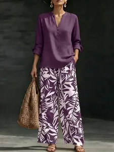 Women’s fashion casual two-piece set featuring a V-neck top with design details paired with wide-leg pants with a botanical pattern; comfortable and breathable, suitable for multiple occasions.