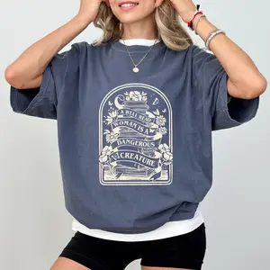 MAPTEES Women's Comfort Colors Graphic T-Shirt - Chic, Oversized, Casual, Comfortable, Loose Fit, "A Well Read Woman Is A Dangerous Creature" Print, Librarian Outfit