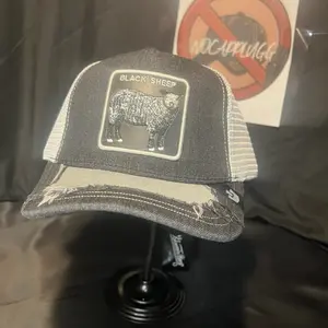Black Sheep Embroidered Trucker Cap with Distressed Design and Patch Detailing