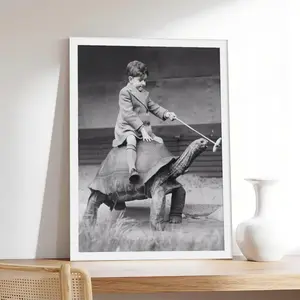 Boy Riding Pet Tortoise _ Black And White Vintage Photo,photo, vintage, couple，Minimalist Neutral Poster Print, Aesthetic Wall Decor for Bedroom.