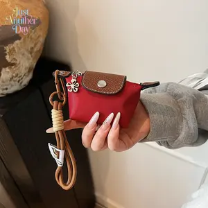 Mini Red Nylon Coin Purse with Brown Contrast Faux Leather Trim Cute Snap Button Pouch with Floral Charm and Wrist Strap Lightweight Keychain and Lipstick Bag Stylish and Compact Accessory Ideal Gift for Her