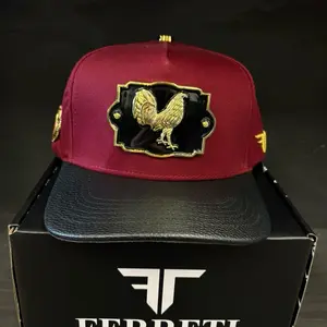 Ferretti Gorra Gallo de Oro Maroon Snapback Hat with Gold Rooster Emblem and Black Leather Brim