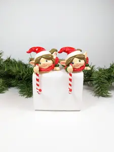 House of Lloyd Elf holding a Candy Cane Stocking Holders