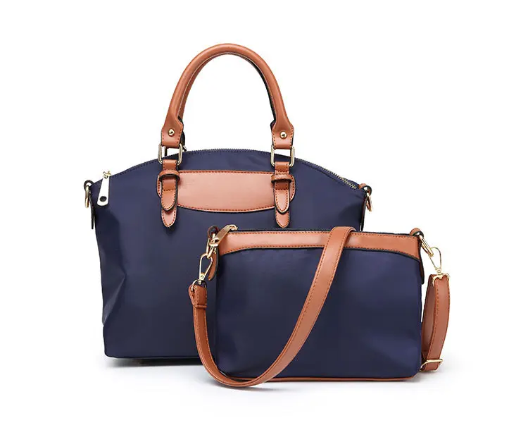 Elegant Navy Blue Handbag with Brown Leather Accents and Adjustable Strap for Versatile Use