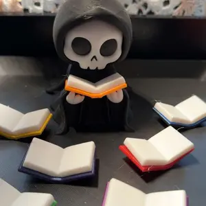 Spooky Ghost Face Reading books. Surrounded by books in several colors