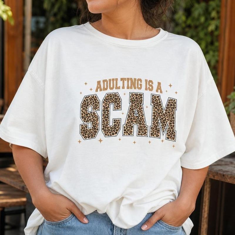 Women's 100% Cotton Loose-Fit Crew Neck Short Sleeve Leopard Print Tshirt - Breathable Drop Shoulder Top with Sarcastic "Adulting Is a Scam" Graphic for Casual Wear