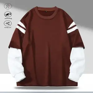 A long sleeve top with a contrasting two piece look, styled between casual sports and retro. The brown tones are grounded and vintage inspired, while the white accents (striped sleeves and shoulders) add a fresh feel and design details. The faux two piece