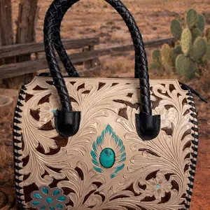 Medium tooled leather speedy with a turquoise stone.