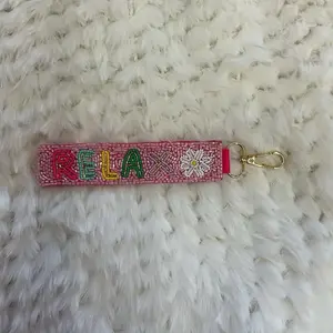 Beaded Keychain - Red String with Embroidered "RELAX" and Flower Design Handmade in India Includes Clip Attachment