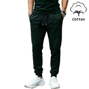 Men’s cotton casual pants made from breathable fabric, featuring an elastic waistband with drawstring, secure zippered pockets, and cuffed leg openings for comfortable wear. Suitable for gym workouts, leisure time, and streetwear styling.