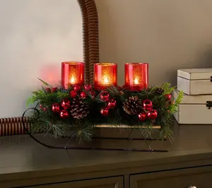 Illuminated Sleigh Centerpiece with Greenery by Valerie
