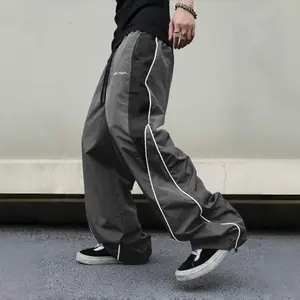 Men’s black color-block athletic pants with white side stripes and embroidery design, casual fitness wear, loose sports long pants, stylish street-style jogging pants, drawstring waist, straight-leg cut, polyester fabric Baggy Wide Sweatpants