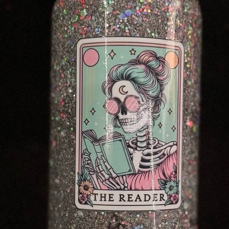 16oz Snow Globe Cup with Silver Glitter and Skull Design Featuring "The Reader" Saying