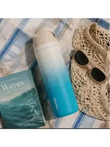 Owala FreeSip stainless steel water bottle in the "Rolling In" colorway features a coastal-inspired cream-to-blue gradient design