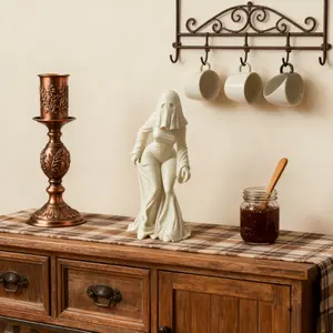 A ghost figurine, with ill-fitting clothes, is perfect for placing on a desk or near the entrance. It suits various settings and