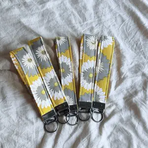 Yellow Daisy Wristlet with Floral Pattern and Key Ring Hardware