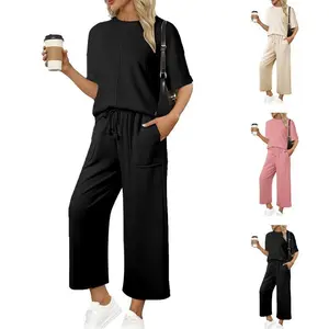 Women’s two-piece sports set featuring a casual short-sleeve pullover and drawstring wide-leg pants, suitable for casual or everyday wear GARMENTARY