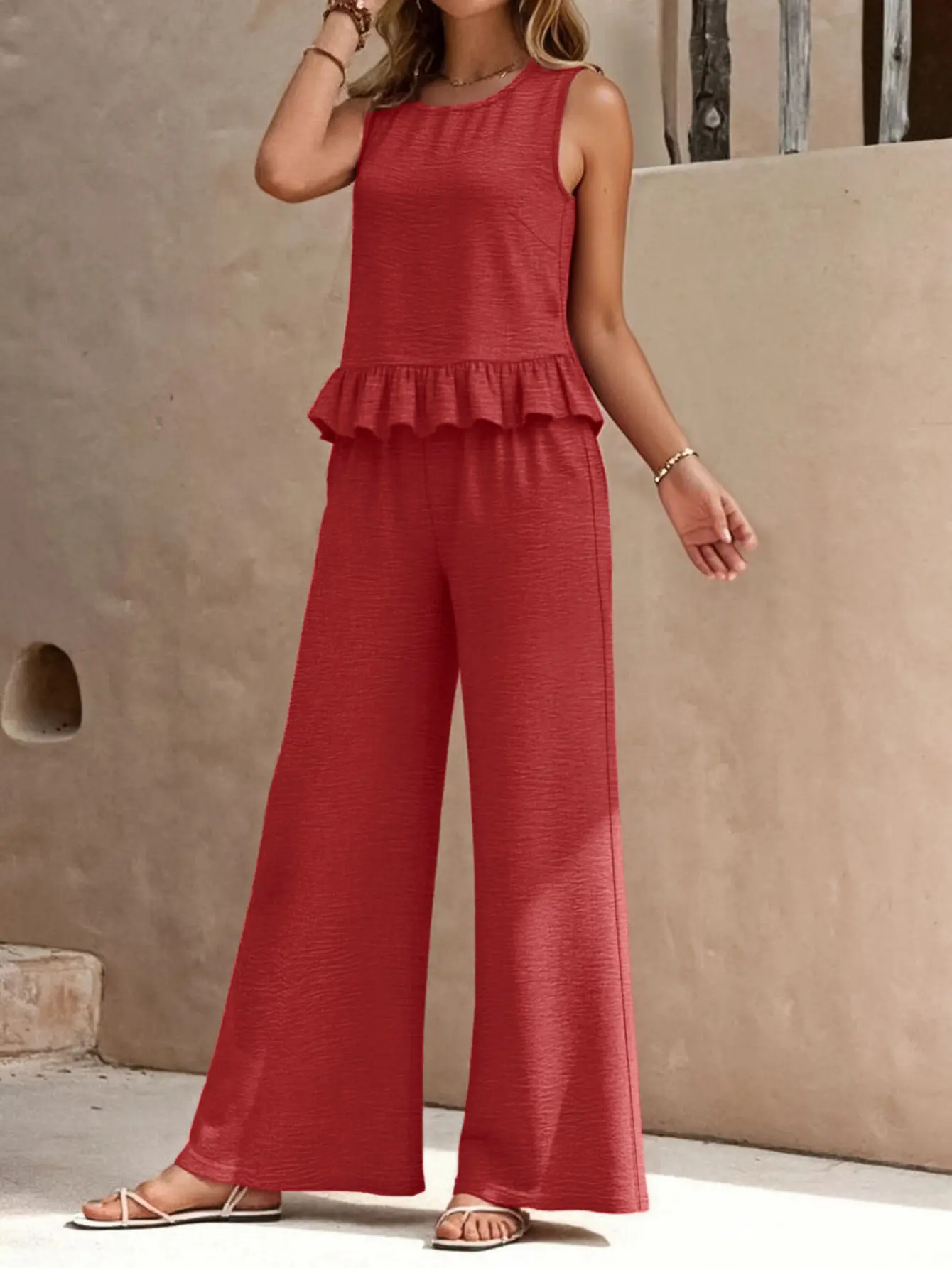 Women’s summer two-piece outfit: sleeveless round-neck peplum tank top with ruffles and high-waisted wide-leg long pants; casual solid matching set for vacation lounge wear