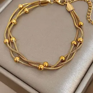 Pulsera tres cadenas con balines de acero inoxidable chapado en oro 18k